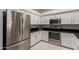 Modern kitchen with stainless steel appliances, white cabinets, and black countertops at 7006 E Jensen St # 40, Mesa, AZ 85207
