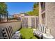 Cozy backyard featuring an artificial lawn, a privacy wall, and striped outdoor furniture at 7315 E Arlington Rd, Scottsdale, AZ 85250
