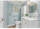 Stylish powder room features new fixtures, a vanity and a decorative mirror at 7315 E Arlington Rd, Scottsdale, AZ 85250