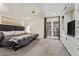 Primary bedroom with french doors, plush carpet, ceiling fan, and built-in white display shelving at 7315 E Arlington Rd, Scottsdale, AZ 85250