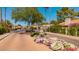 Gated community entrance with water feature, landscaping, and manicured bushes at 7315 E Arlington Rd, Scottsdale, AZ 85250