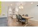 Bright dining area with hardwood floors, stylish lighting, and a glimpse into the modern kitchen at 7315 E Arlington Rd, Scottsdale, AZ 85250