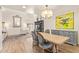 Elegant dining area featuring hardwood floors, a chandelier, and seamless access to the living room at 7315 E Arlington Rd, Scottsdale, AZ 85250
