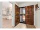 Inviting foyer with wooden floors, a decorative front door, and a glimpse into the bright kitchen at 7315 E Arlington Rd, Scottsdale, AZ 85250