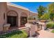 Charming home entrance with decorative ironwork, terracotta tiles, and beautiful potted plants, offering curb appeal at 7315 E Arlington Rd, Scottsdale, AZ 85250