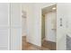 Hallway featuring hardwood floors and access to the bathroom and storage at 7315 E Arlington Rd, Scottsdale, AZ 85250