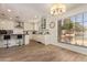 Bright kitchen features wood floors, white cabinets, stainless steel appliances and a large window at 7315 E Arlington Rd, Scottsdale, AZ 85250
