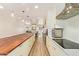 Open concept kitchen with stainless steel appliances, white cabinets, and a large breakfast bar at 7315 E Arlington Rd, Scottsdale, AZ 85250