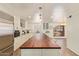Spacious kitchen features wood floors, stainless steel appliances, and a large breakfast bar at 7315 E Arlington Rd, Scottsdale, AZ 85250
