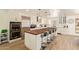 Bright kitchen features wood floors, stainless steel appliances, large breakfast bar and white cabinets at 7315 E Arlington Rd, Scottsdale, AZ 85250