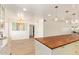 Bright kitchen boasts white cabinets, granite counters, stainless appliances, and wood-look tile flooring at 7315 E Arlington Rd, Scottsdale, AZ 85250