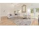 Bright living room with high ceilings, large windows, neutral furniture, and hardwood floors at 7315 E Arlington Rd, Scottsdale, AZ 85250