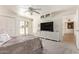Spacious main bedroom featuring plush carpet, patio access, and an entertainment center at 7315 E Arlington Rd, Scottsdale, AZ 85250