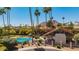 Aerial view of community pool featuring lounge chairs, shade, and lush landscaping at 7315 E Arlington Rd, Scottsdale, AZ 85250