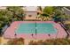 Community tennis court with fencing and lighting, surrounded by lush greenery at 7315 E Arlington Rd, Scottsdale, AZ 85250