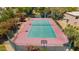 Aerial view of a tennis court with basketball hoop surrounded by mature trees at 7315 E Arlington Rd, Scottsdale, AZ 85250