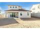 Stucco exterior of the home with a backyard featuring an outdoor patio and ample space at 7444 W Buckhorn Trl, Peoria, AZ 85383
