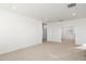 Spacious bedroom with carpeting, light walls, and multiple entryways to other rooms at 7444 W Buckhorn Trl, Peoria, AZ 85383