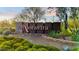 Community entrance featuring the Aloravita sign amidst lush greenery and desert landscaping at 7444 W Buckhorn Trl, Peoria, AZ 85383