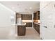 Open kitchen features stylish cabinetry, a center island with sink, and modern appliances at 7444 W Buckhorn Trl, Peoria, AZ 85383