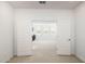 Bright, open loft space seen through white double doors, featuring neutral carpet and inviting natural light at 7444 W Buckhorn Trl, Peoria, AZ 85383