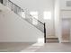 A staircase with modern railing leads to the upper level, bathed in sunlight from the windows at 7444 W Buckhorn Trl, Peoria, AZ 85383