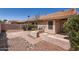 Charming backyard with brick pavers, low walls, and desert landscaping providing a tranquil outdoor space at 7709 W Tonto Dr, Glendale, AZ 85308