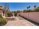 Enclosed backyard featuring brick pavers, desert landscaping, and privacy walls for a serene outdoor experience at 7709 W Tonto Dr, Glendale, AZ 85308