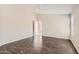 Bright bedroom featuring dark wood floors, neutral walls, and a ceiling fan at 7709 W Tonto Dr, Glendale, AZ 85308