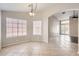 Bright dining area adjacent to the living room features large windows and stylish light fixture at 7709 W Tonto Dr, Glendale, AZ 85308