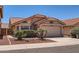 Charming single-story home with a terra cotta roof, desert landscaping and an attached two car garage at 7709 W Tonto Dr, Glendale, AZ 85308