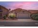 Charming single-Gathering home with a two-car garage and desert landscaping under a beautiful dusk sky at 7709 W Tonto Dr, Glendale, AZ 85308