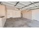 Spacious garage with ample storage cabinets, clean concrete flooring, and bright overhead lighting at 7709 W Tonto Dr, Glendale, AZ 85308