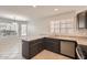 Stylish kitchen with a granite-topped island and sink, complemented by a dining area with abundant natural light at 7709 W Tonto Dr, Glendale, AZ 85308