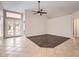 Bright living area with tile flooring, a ceiling fan, and a patio door to a back yard at 7709 W Tonto Dr, Glendale, AZ 85308