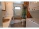 Bathroom featuring a combo shower and tub, vanity, and linen storage at 7807 E Main St # F-35, Mesa, AZ 85207