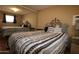 Comfortable bedroom with a stylish headboard and a mirrored wall at 7807 E Main St # F-35, Mesa, AZ 85207