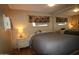 Bedroom with a gray comforter, window, mirrored closet doors and dresser at 7807 E Main St # F-35, Mesa, AZ 85207