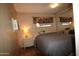 Bedroom with a gray comforter, window, mirrored closet doors and dresser at 7807 E Main St # F-35, Mesa, AZ 85207