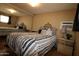 This cozy bedroom features an iron bed frame, black and white bedding and mirrored closet doors at 7807 E Main St # F-35, Mesa, AZ 85207