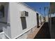 Exterior of mobile home features white siding and window air conditioning unit at 7807 E Main St # F-35, Mesa, AZ 85207