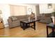 Cozy living room with wood laminate flooring, neutral paint, and comfortable seating at 7807 E Main St # F-35, Mesa, AZ 85207