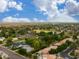 Expansive residential area featuring varied homes with lush greenery, distant horizon, and stunning cloudscape at 8419 E Rancho Vista Dr, Scottsdale, AZ 85251