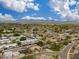 Expansive aerial view of a neighborhood with mountain views and clear blue skies in Scottsdale, Arizona at 8419 E Rancho Vista Dr, Scottsdale, AZ 85251