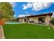 Expansive backyard featuring a pool, patio, lounge seating, and lush landscaping, perfect for outdoor living at 8419 E Rancho Vista Dr, Scottsdale, AZ 85251