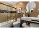 Modern bathroom with unique circular mirror, sleek vanity, and tiled shower-tub combo at 8419 E Rancho Vista Dr, Scottsdale, AZ 85251