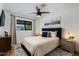 Bright bedroom with ceiling fan, large window, and dark wood accents at 8419 E Rancho Vista Dr, Scottsdale, AZ 85251