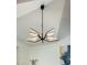 Close-up of a modern chandelier with leaf-shaped lights and clean lines at 8419 E Rancho Vista Dr, Scottsdale, AZ 85251