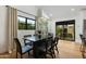 Dining area with modern table, elegant chairs, and glass doors leading to outdoor space at 8419 E Rancho Vista Dr, Scottsdale, AZ 85251