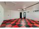 Spacious garage featuring a modern door, bright lighting, and unique checkered flooring at 8419 E Rancho Vista Dr, Scottsdale, AZ 85251